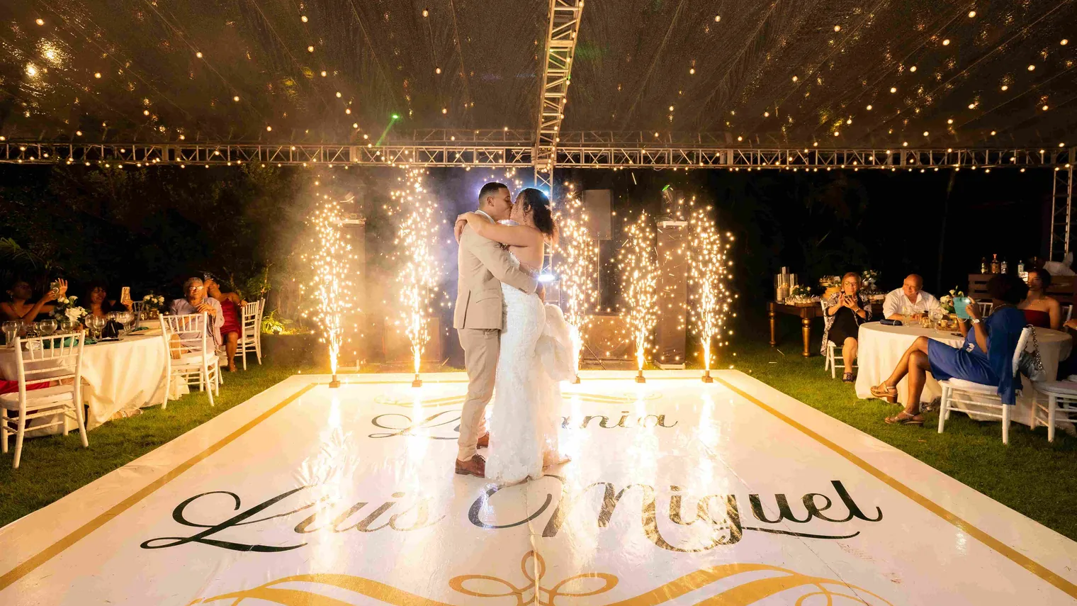 Couple's first dance with cold sparklers on a private reception floor