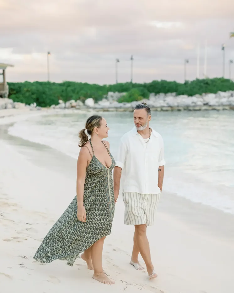Couple walking along the beach at sunset