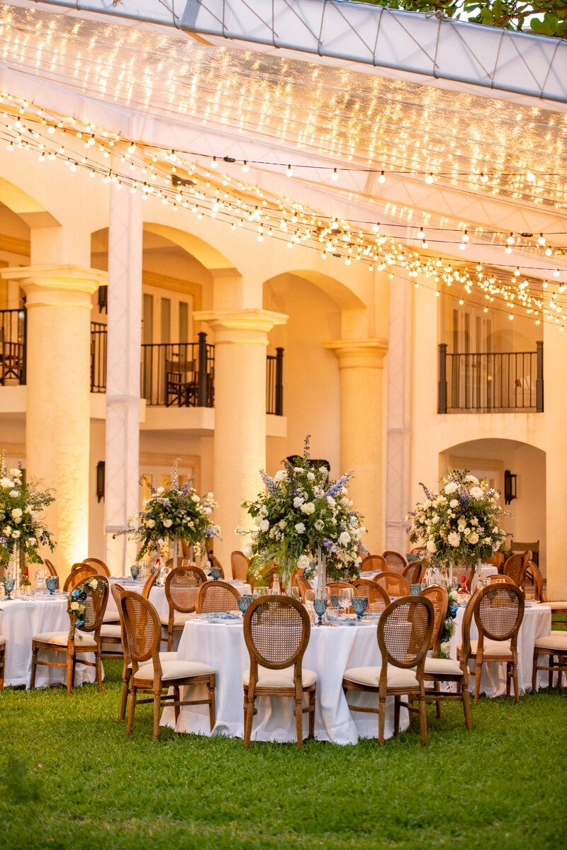 Elegant courtyard reception at a boutique hotel, decorated with white florals